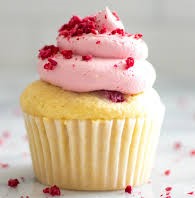 Image of a vanilla cupcake with strawberry cream and flaky red sprinkles